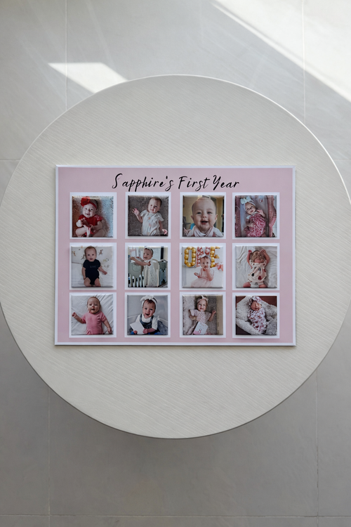 Collage of a baby's first year photos on a pink background with text, displayed on a white wall.